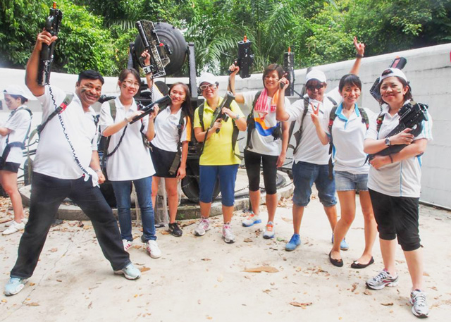 Group enjoying laser tag team building in Singapore.